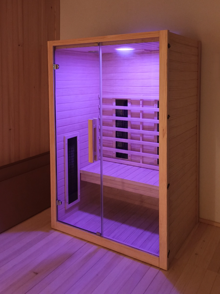 JJSPA JIO120 infrared sauna with purple light on.